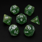 Set of green polyhedral dice with white numbers on a black background