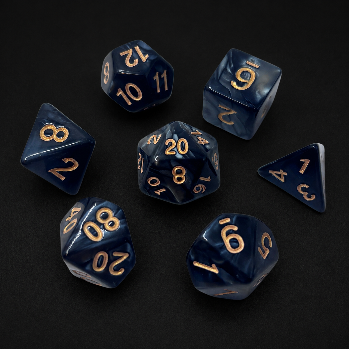 Set of blue polyhedral dice with gold numbers on a black background