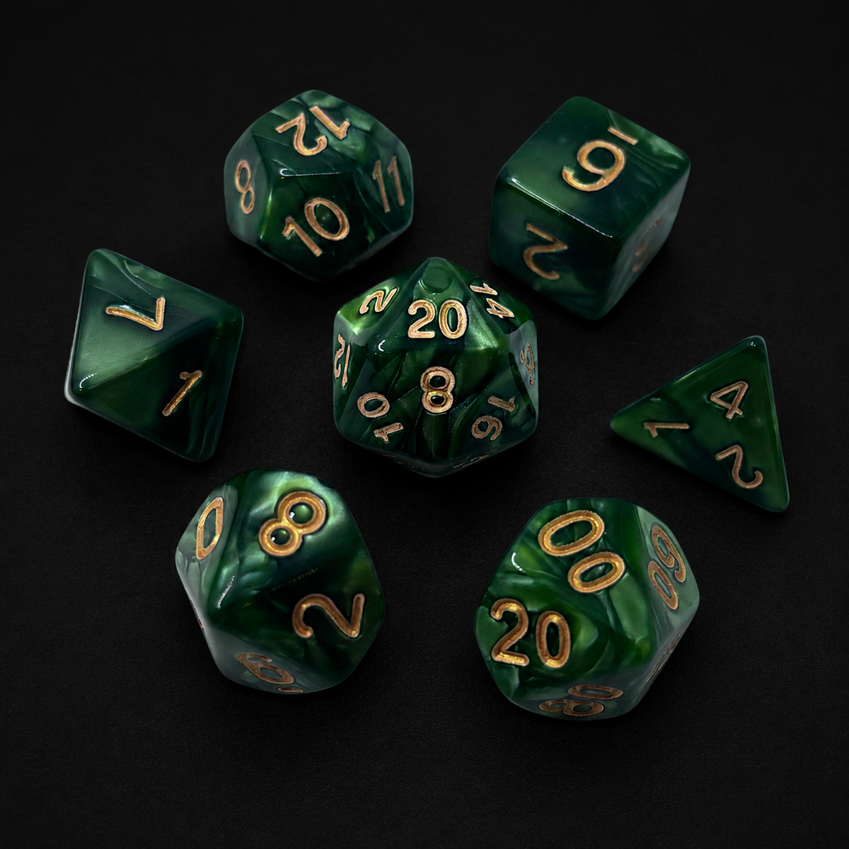 Set of green polyhedral dice with gold numbers on a black background