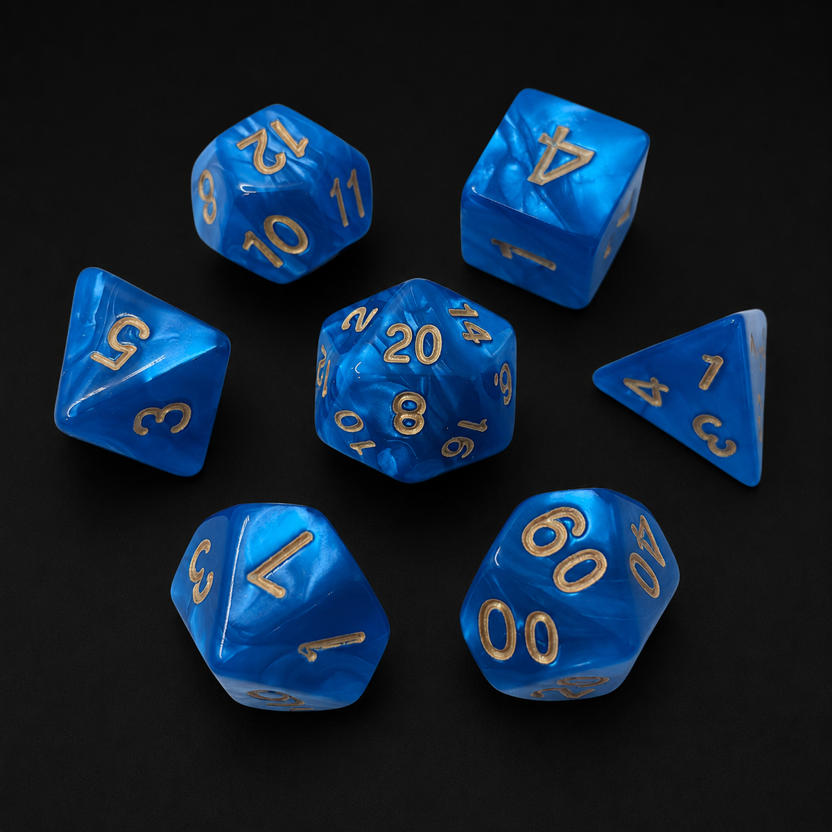 Set of blue polyhedral dice with gold numbers on a black background