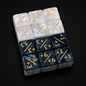 Set of dice with numbers and symbols on a black background