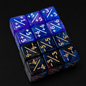 Set of blue and black polyhedral dice with numerical and fractional values on a black background
