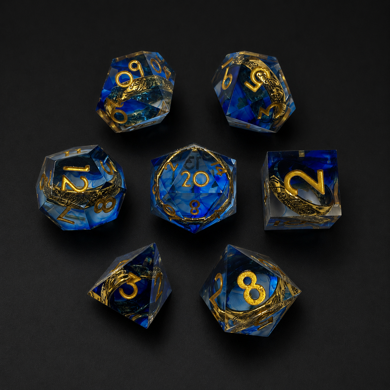 Set of blue and gold polyhedral dice on a black background
